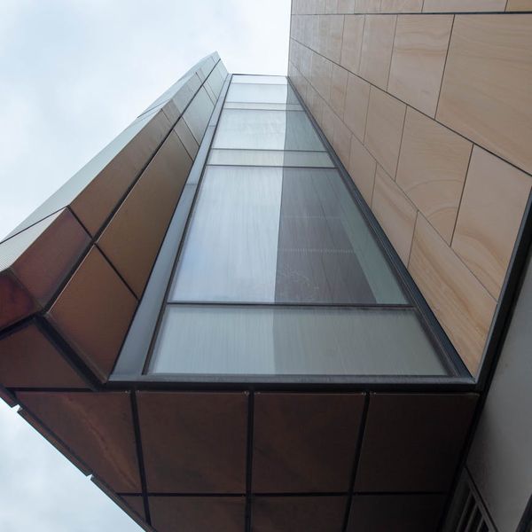 A modern and clean studio space with large windows and mirrors.